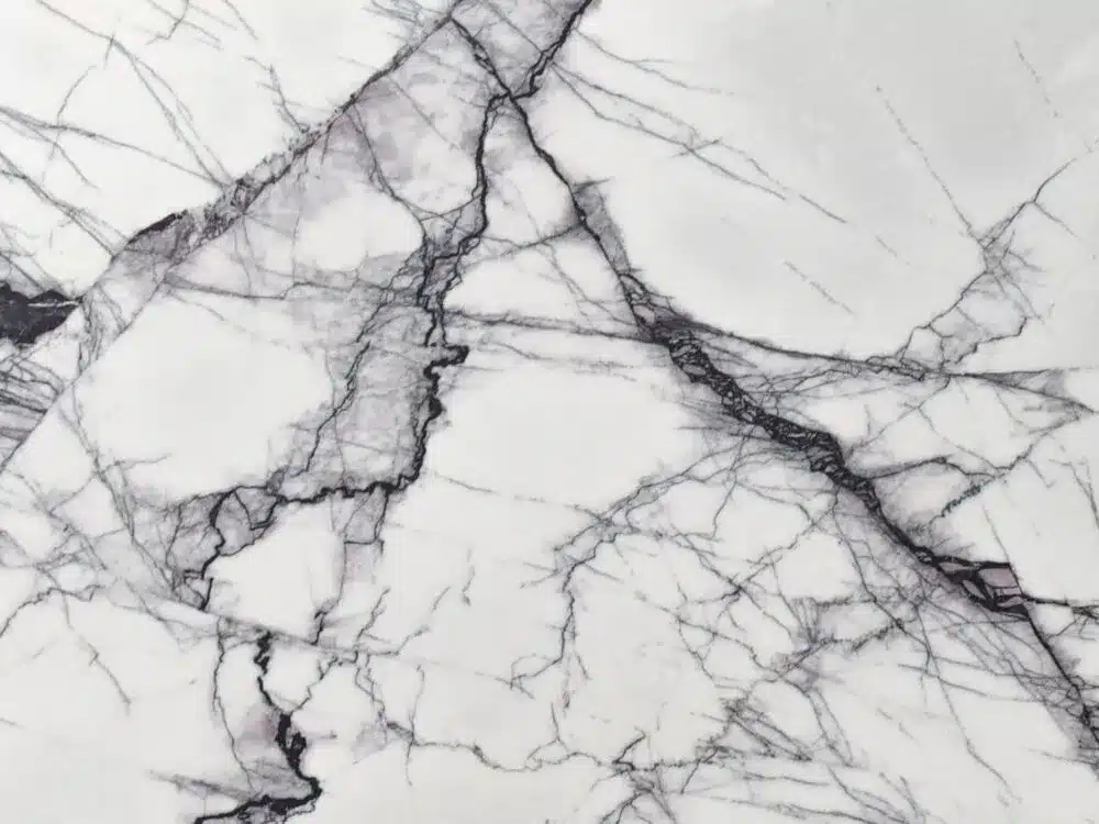 Close-up of a white marble kitchen benchtop with dark gray and black veining patterns in Sydney.